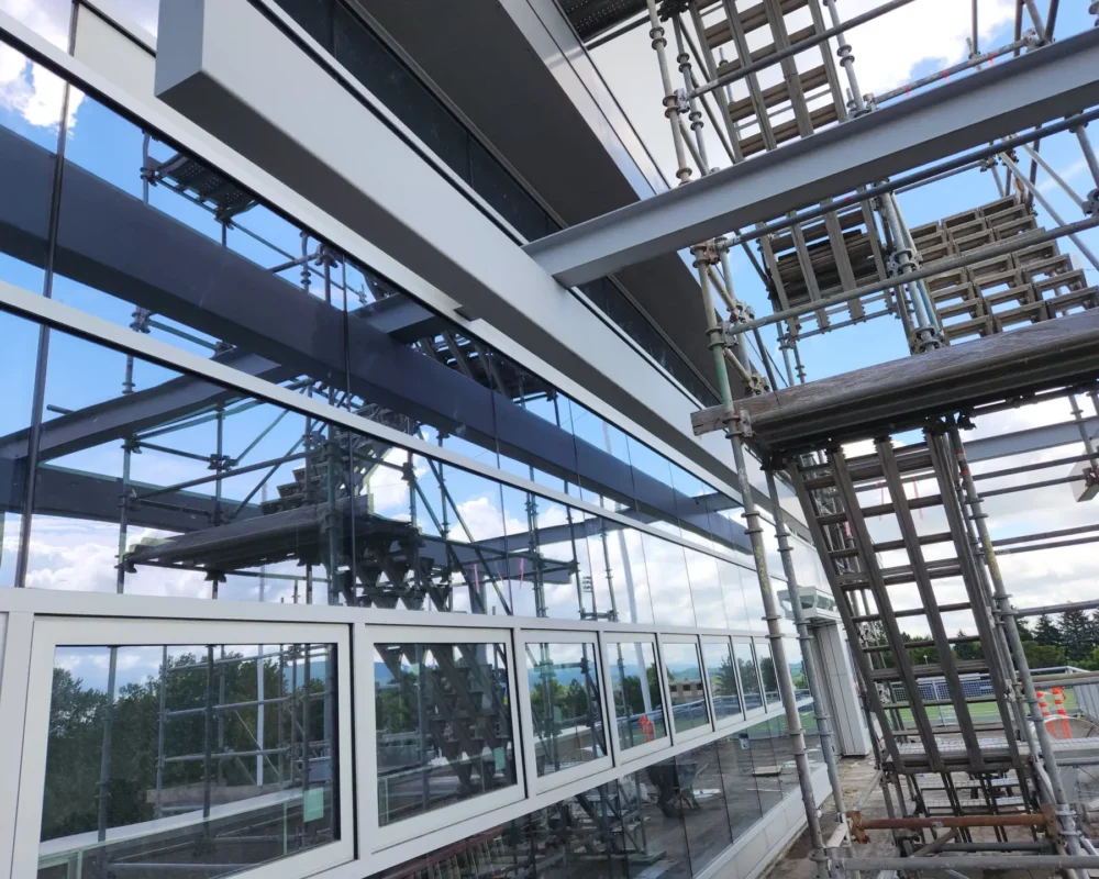 Exterior glass windows and metal scaffolding of a modern Penn State University building